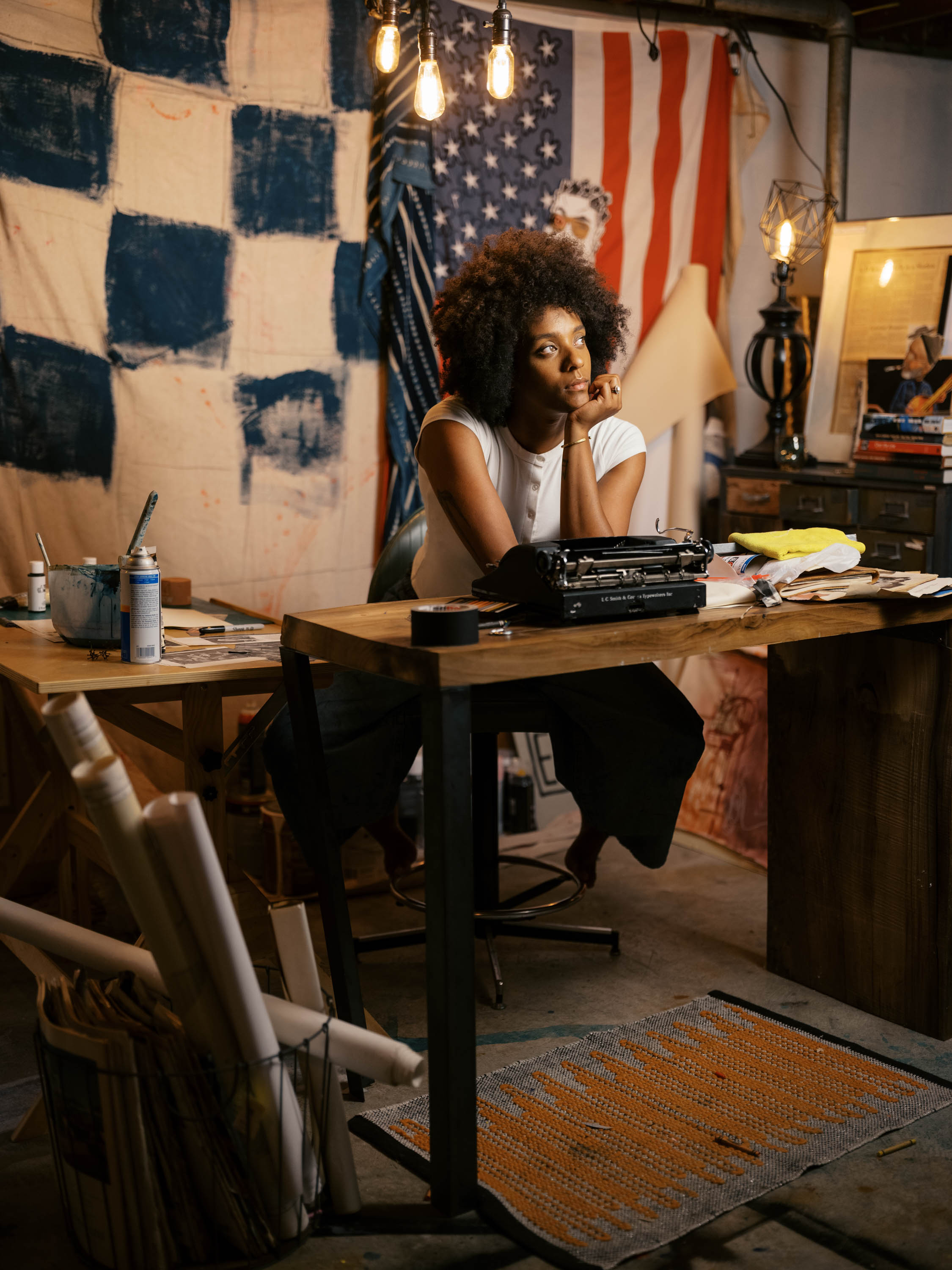 Zandy Mowry seated at a vintage typewriter in her studio